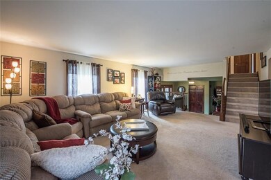 A few steps up and open to the entry, kitchen and 