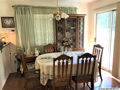 THE LIVING ROOM OPENS TO DINING ROOM WITH LARGE GLASS SLIDING DOORS TO THE COVERED DECK.