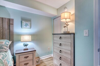 Bedroom with light wood finished floors and baseboards