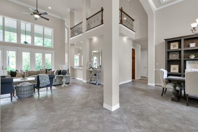 Spacious and open concept living area with balcony overlooking from second floor entertainment space