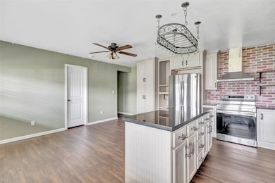 This spacious kitchen features plank wood like flo