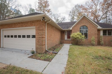 Ranch-style home with a front yard and a garage