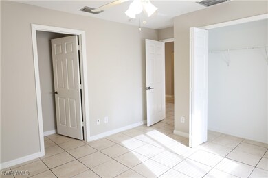 Unfurnished bedroom with a closet, light tile patt