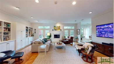 The sunken living room is light & airy with a plet