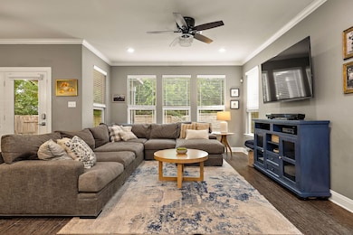 Living area featuring a ceiling fan, recessed lig