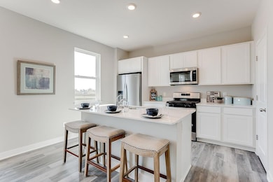 Great eat in kitchen with spacious island and walk in pantry. Photo of model home, color & options will vary.
