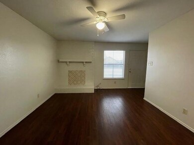 Unfurnished living room featuring dark hardwood / 