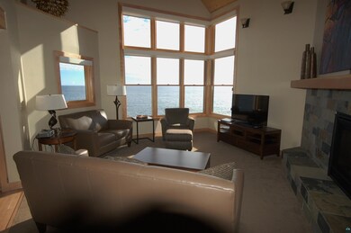Living room featuring light carpet, a high ceiling