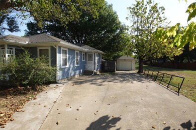 View of home's exterior with a garage, a lawn, and
