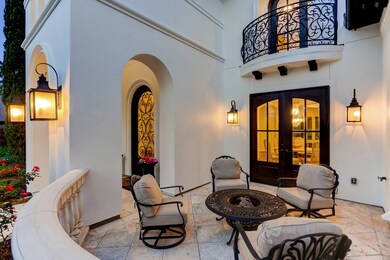 A charming courtyard off the formal dining room invites al fresco entertaining while nodding to the extraordinary outdoor space found throughout this special property.