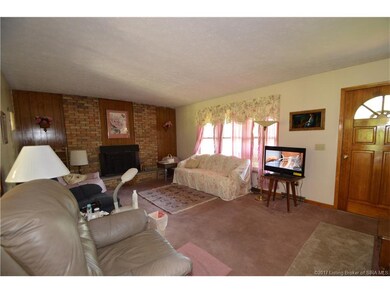 Living room has triple window for lots of natural 