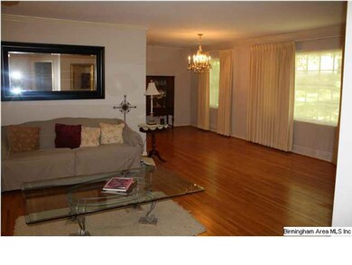 Huge living space with view of dining room and har