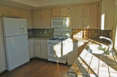The cheery & bright Kitchen features wood flooring