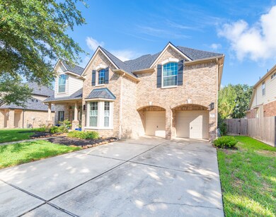 Double wide driveway leading to the 3 car tandem garage.