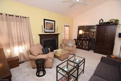 Living room has vaulted ceiling and gas log fireplace.  Glass door open onto spacious deck.
