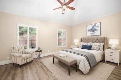 Your spacious primary bedroom has all the space and comfort to rest. This photo has been digitally staged.