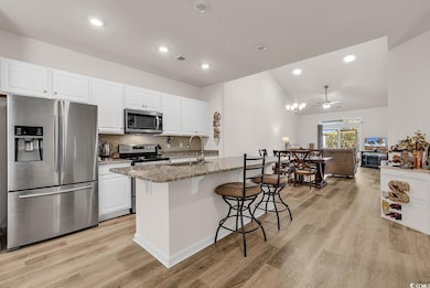 Kitchen featuring stone counters, appliances with 