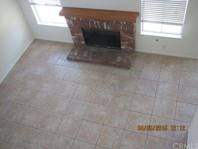 Bright living room with ceramic tile and a brick f