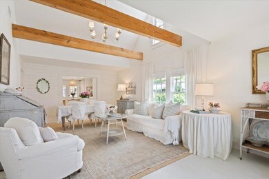 Living room featuring lofted ceiling with beams a