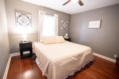 Bedroom featuring wood finished floors, baseboard