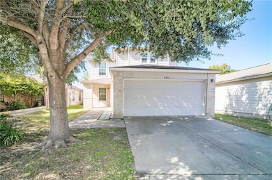 View of front of house with concrete driveway, brick siding, and a garage