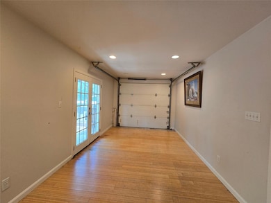 Garage featuring french doors and recessed lighti