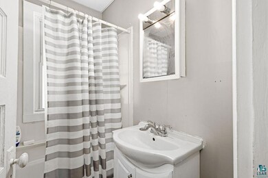 Bathroom with curtained shower and vanity