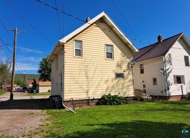 View of property exterior with a lawn