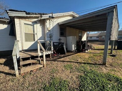 Rear view of property featuring a carport