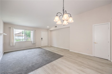 Entryway featuring a chandelier, light wood-style