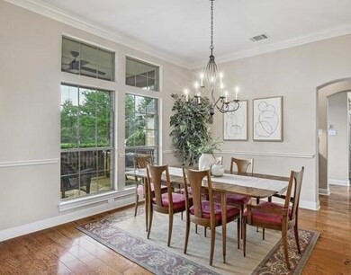 Dining area featuring crown molding, arched walkw
