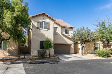 Mediterranean / spanish house with stucco siding, a tile roof, and concrete driveway