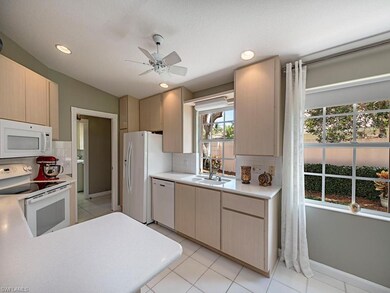 Natural sunlight fills the kitchen (complete with 