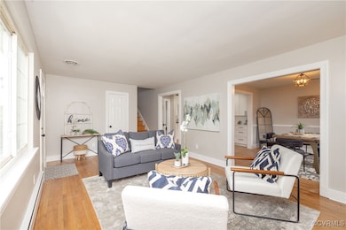Living room featuring stairway, a baseboard radiat