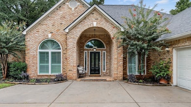 This home features a charming brick facade with an