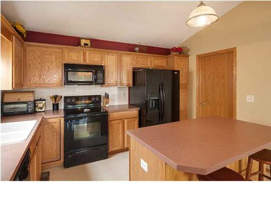 Kitchen has center island/eating bar.