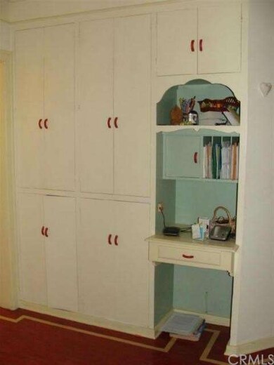 Kitchen cabinetry and display case with desk (walk