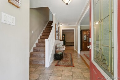 Tiled entryway with crown molding