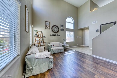 Spacious front living room with beautiful wood lam