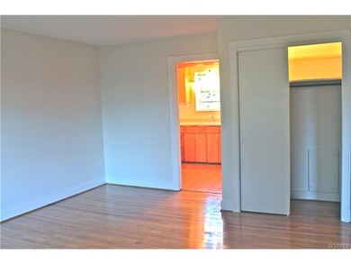 View from living room looking into kitchen and coa