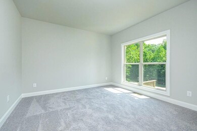 Empty room featuring baseboards and carpet floorin