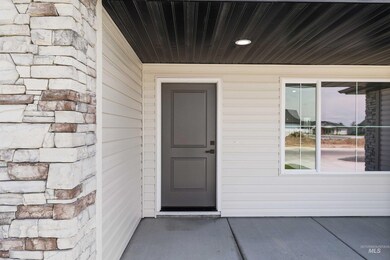 Doorway to property featuring stone siding