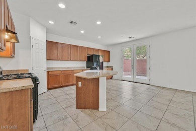 Kitchen featuring gas range, french doors, recesse