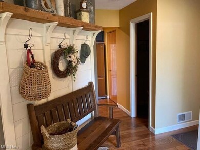 features wood flooring leading into kitchen