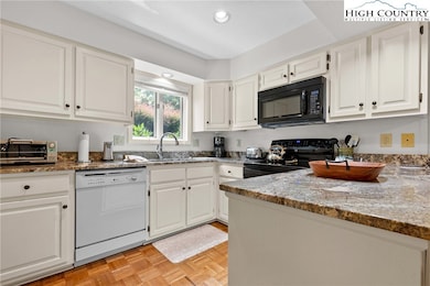 Kitchen has pretty granite counters light cabinets