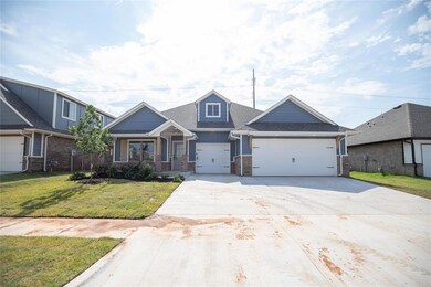 View of front facade with a garage, driveway, a front yard, brick siding, and a shingled roof