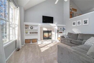Great room has built in shelves and a gas fireplac