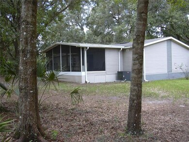 View of home and trees near northwest corner of th