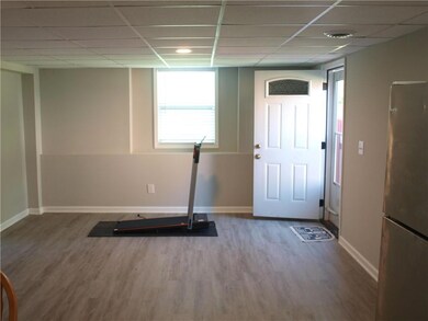 Workout room featuring baseboards, wood finished floors, and a drop ceiling
