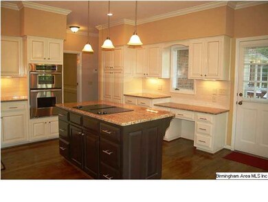 Kitchen has desk, pantry with revolving shelves, a